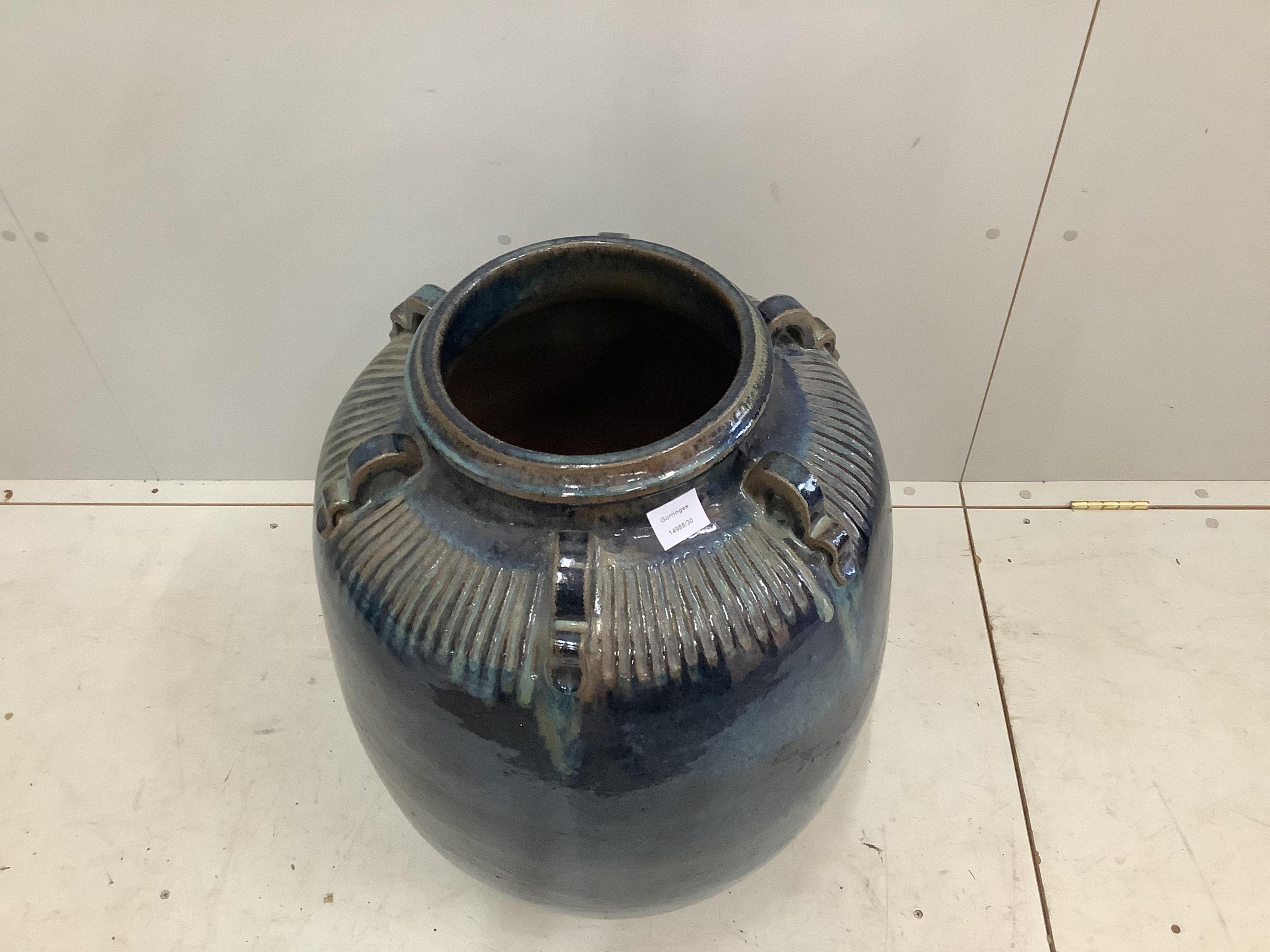 Monica Young (1929-2004), a large blue glazed earthenware vase, the neck applied with six ring handles, impressed studio mark, height 75cm. Condition - good